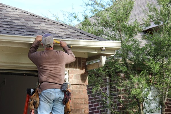 diy gutter installation, Installing,Roof,Gutters;,Worker,Attaching,Aluminum,Rain,Gutter,And,Down