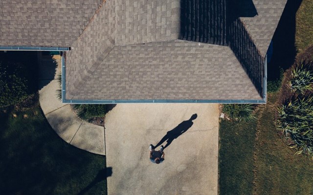 man-standing-in-front-of-roof