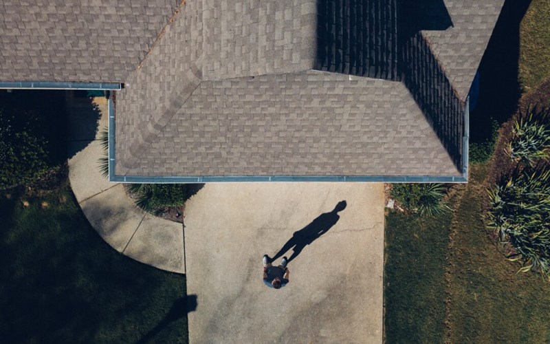 man-standing-in-front-of-roof