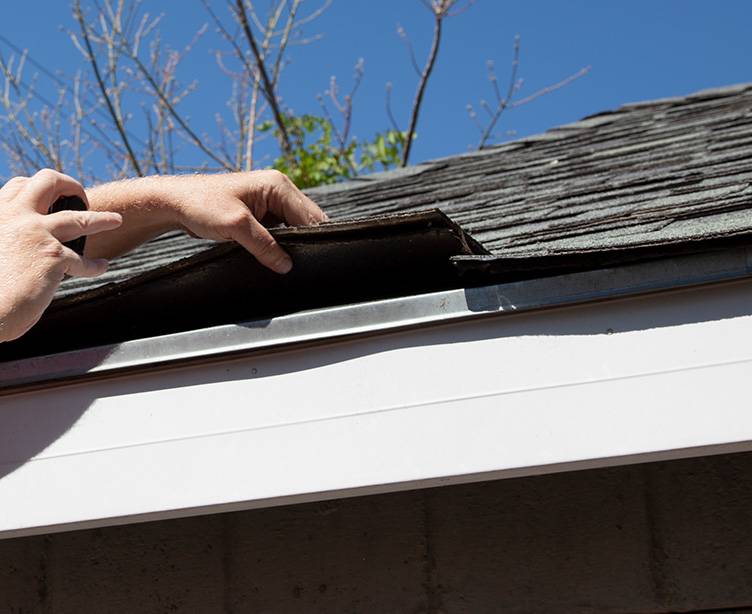 Expert roofer inspecting a roof in Grand Rapids