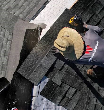 Roof repair with new shingles and flashing in progress by our roofing professionals