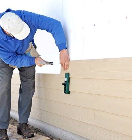 Siding replacement in progress on a residential home